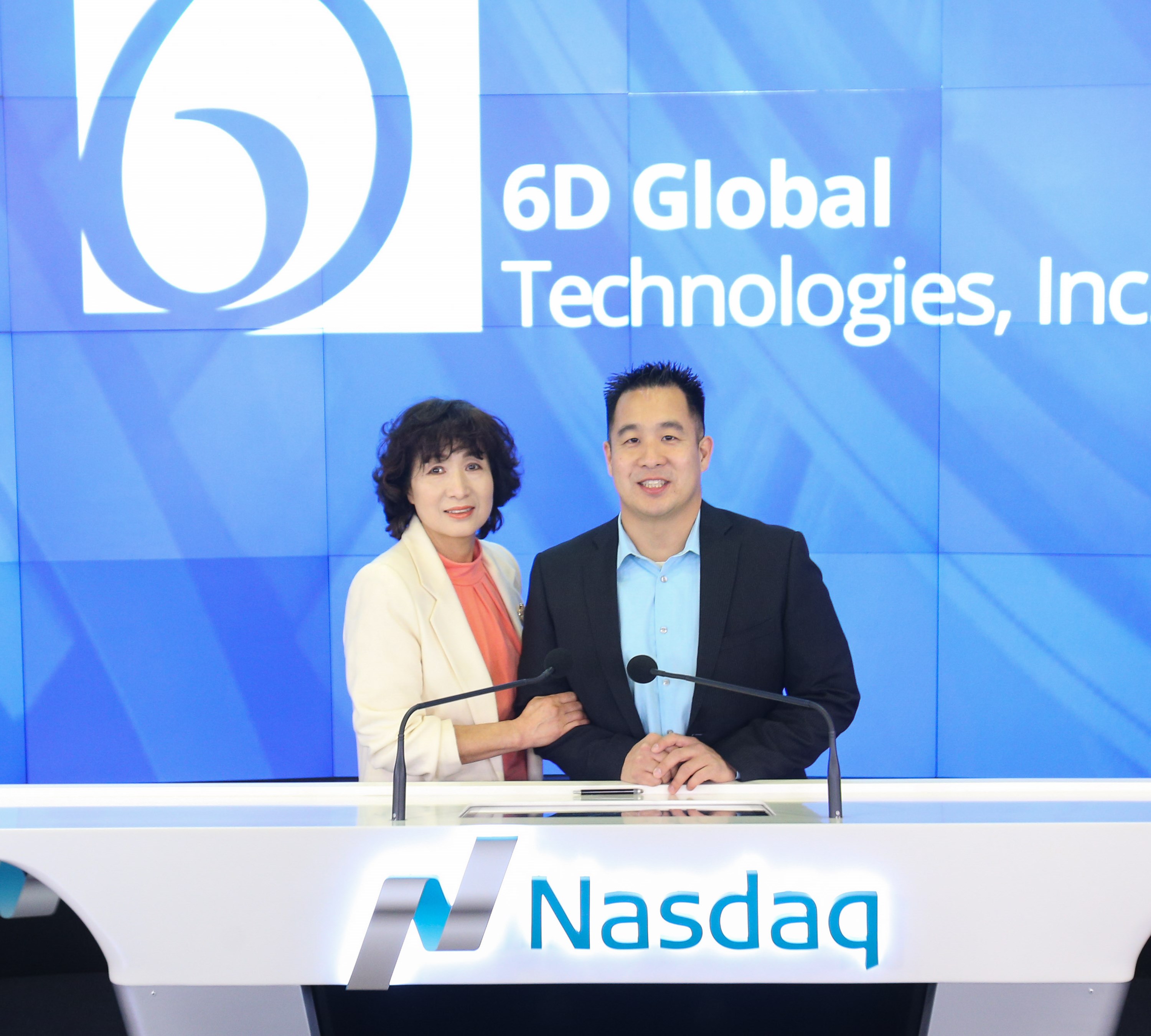 Tejune Kang with his mother at the Nasdaq MarketSite podium on listing day for 6D Global Technologies